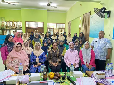 Warga berfoto bersama di ruang pertemuan